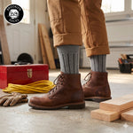 Brooklyn Socks cushioned cotton crew socks worn with work boots in a home workshop